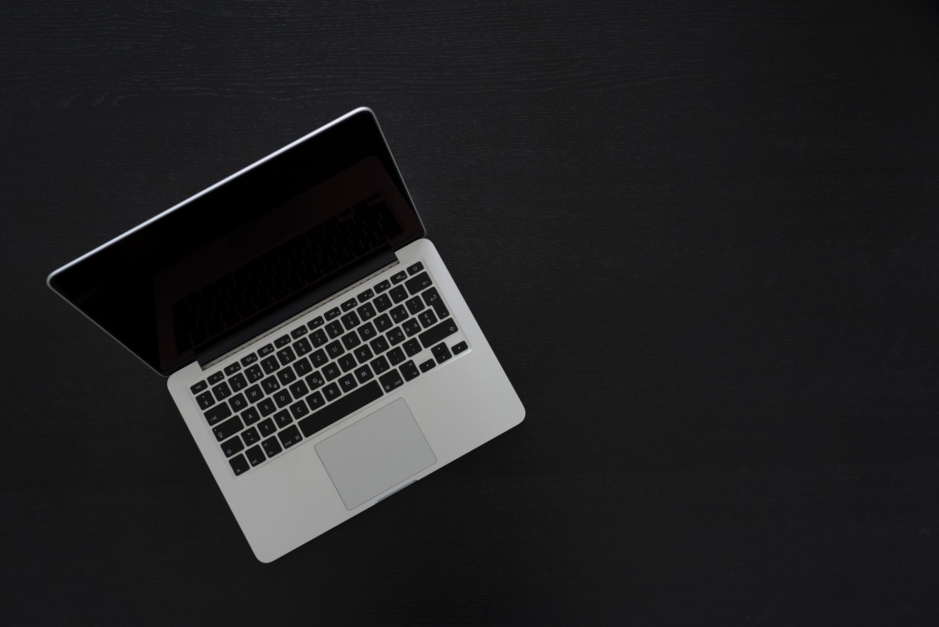 A tidy desk with a notebook, laptop and coffee — where marketing experiments happen